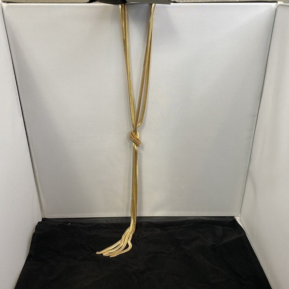 Thalia Sodi gold colored long knotted necklace with tassel. Adjustable length